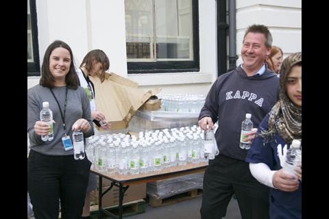 Law Society staff hand out bottled water before the start.